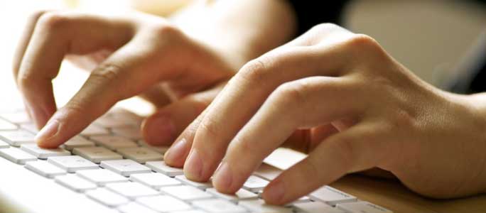 Typing on a laptop