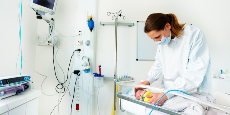 A midwife attends to a newborn