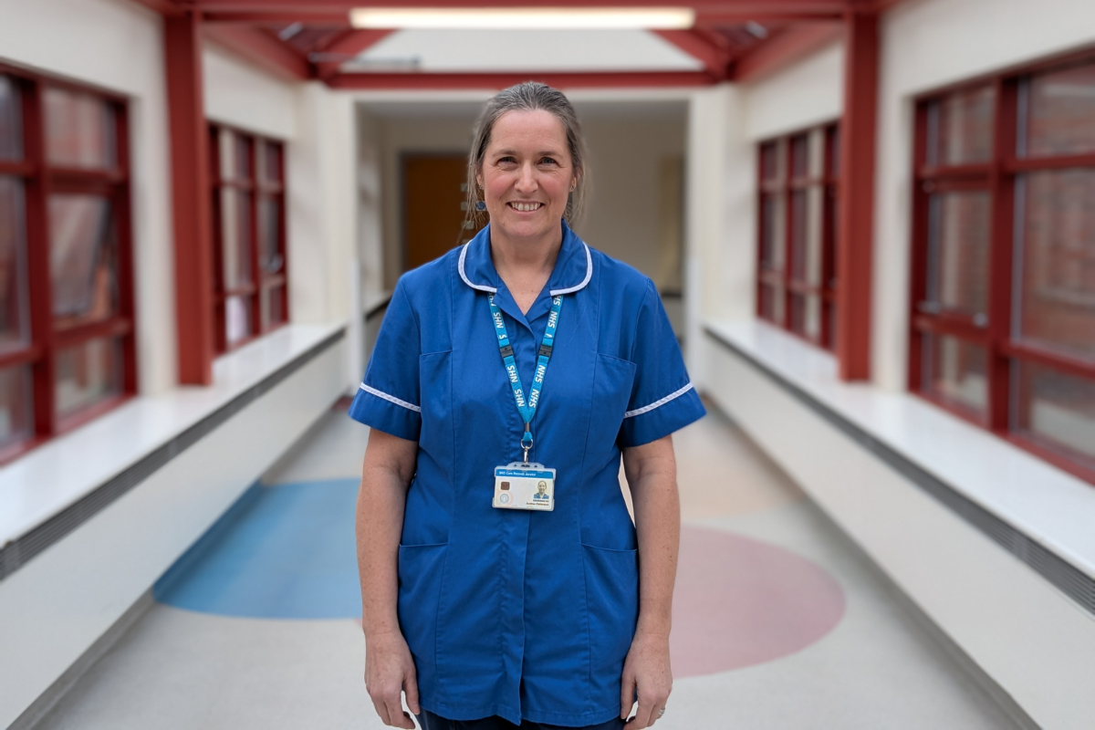 Nurse smiling in corridor
