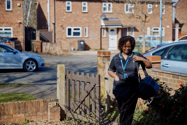 Community nurse walking in garden