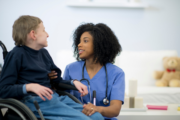 Learning disability nurse with child in wheelchair