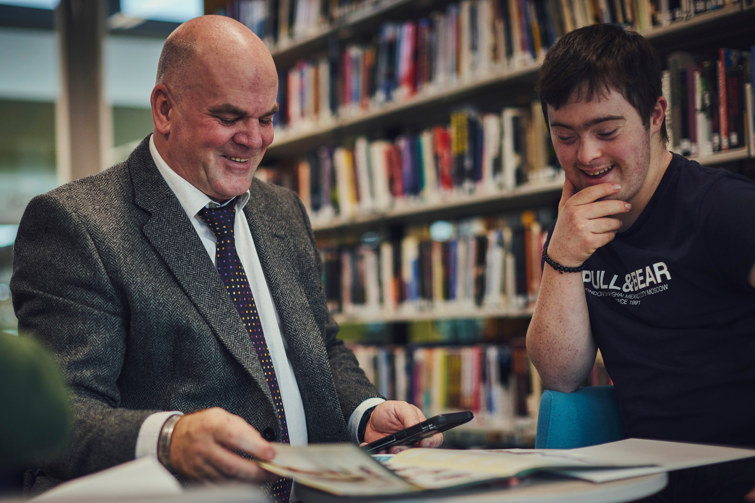 Down's Syndrome man in library