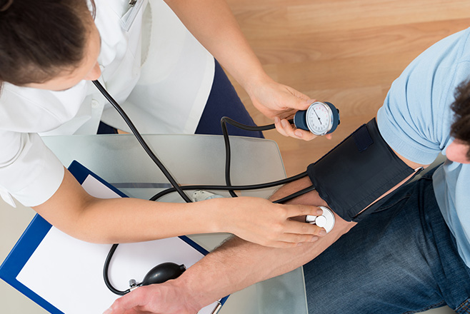 Nurse taking a man's blood pressure