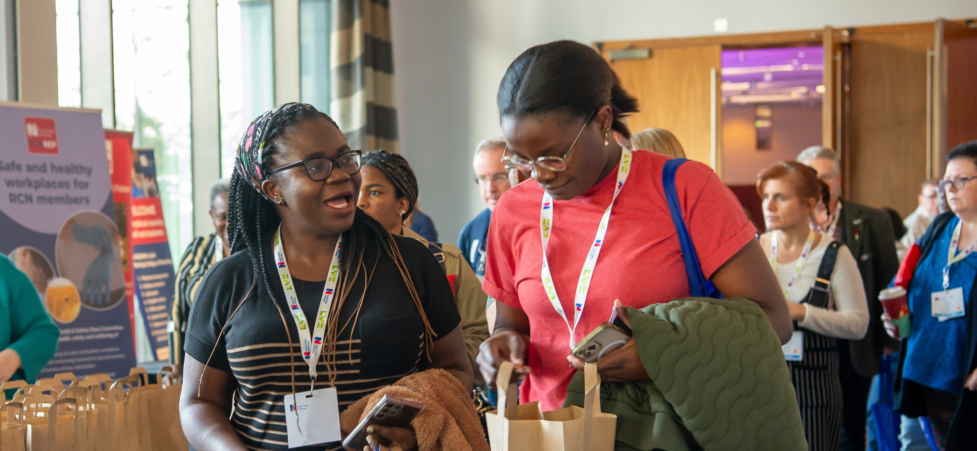 Two women talking to each other at a conference