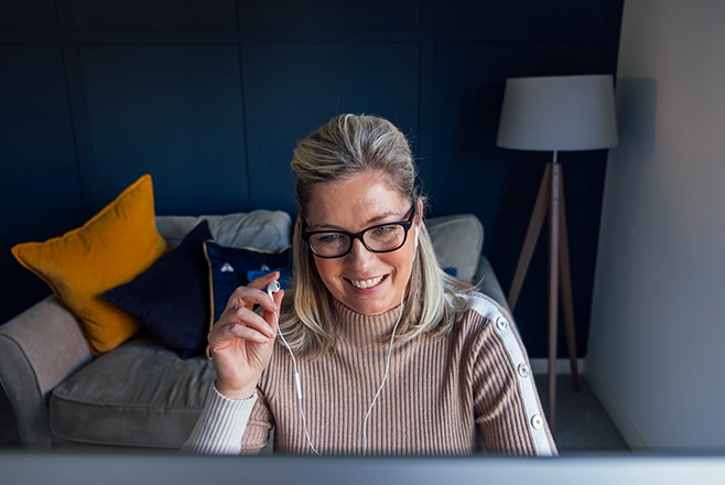 Woman with headphones on at desk