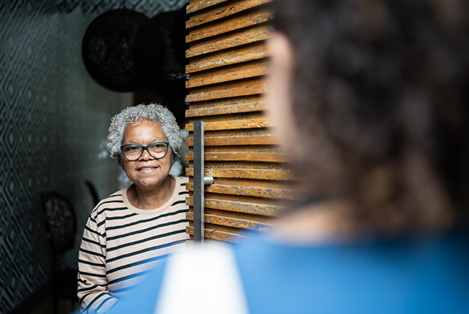 Woman opening the door to a nurse