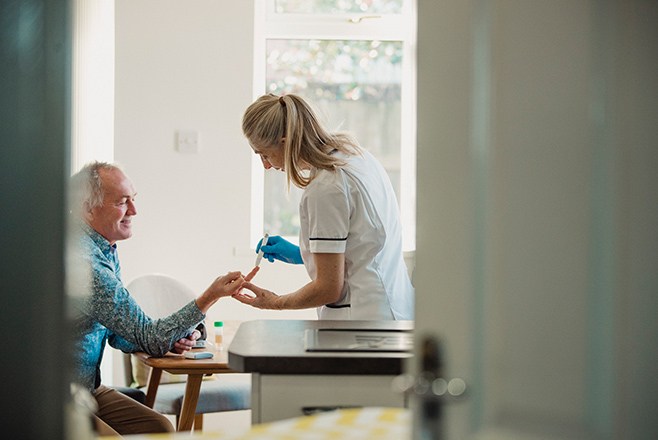 Nurse helping a male patient with diabetes