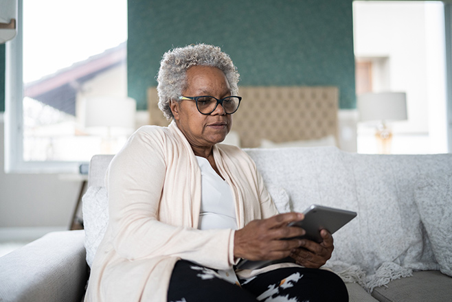 An elderly woman looking at her phone