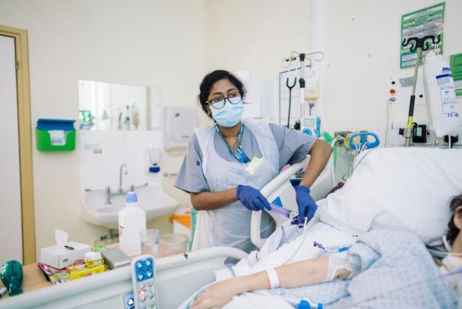 Nurse looking after a patient in intensive care