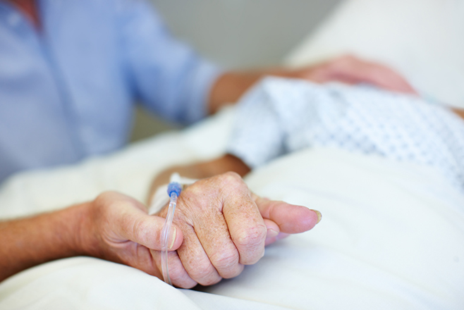 Nurse holding a patient's hand
