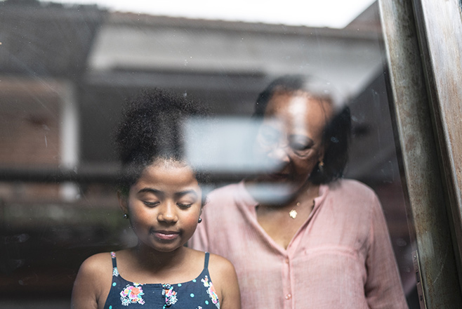 A woman looking down at a young girl