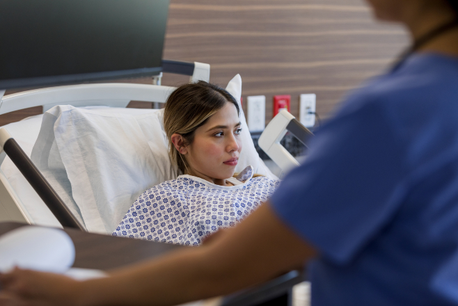 Lady sitting up in a hospital bed