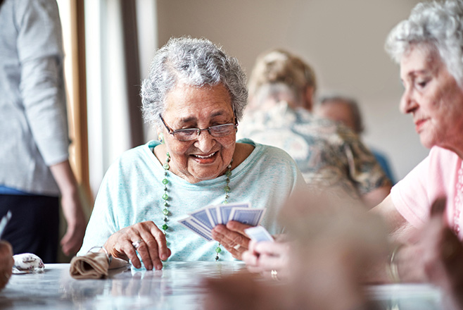Two ladies playing cards together