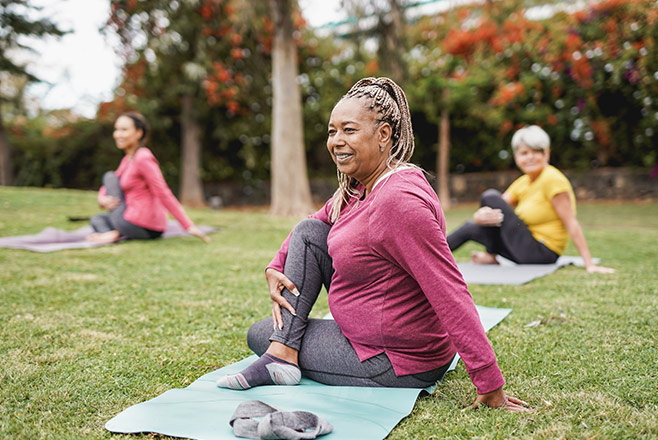 A group of women doing yoga outdoors