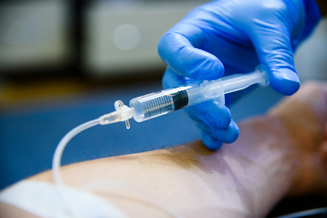 Nurse administering medicine into patient
