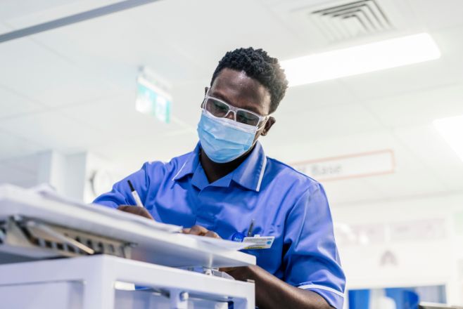 Male nurse writing on paper