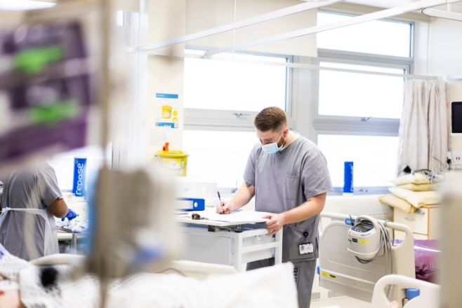 Male nurse working out some numbers