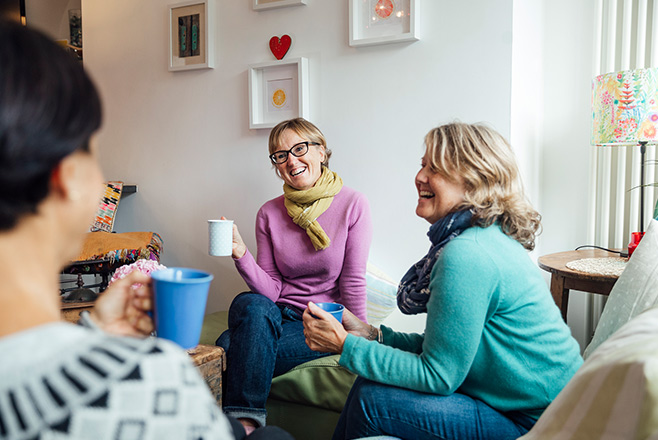 Three women laughing and talking