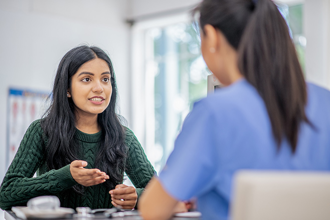 A nurse talking to a woman