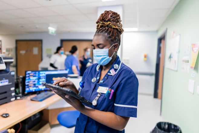 Female nurse using an electronic device