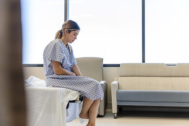 A woman sitting on a hospital bed