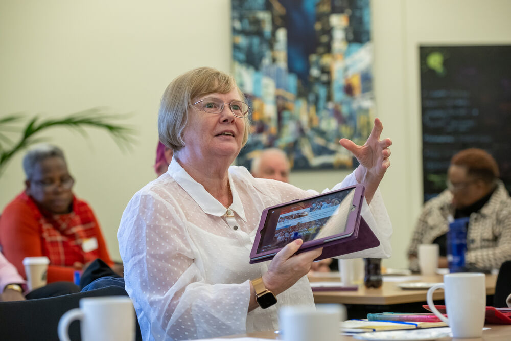 An RCN rep holding an ipad with the RCN website on the screen