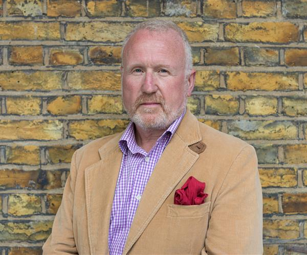 An image of Tristan Griffin, RCN Council member for Wales, standing in front of a brick wall
