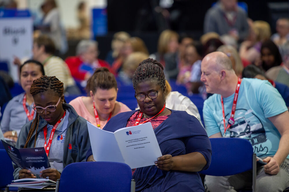 Members reading AGM documents at RCN Congress