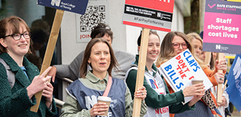 RCN members standing together on strike