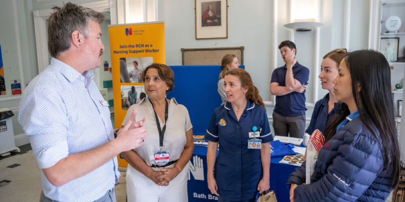 RCN Council member for the South West Ashleigh Taylor talking to RCN General Secretary and Chief Executive Professor Nicola Ranger and a group of RCN members in front of an RCN Bath Branch stand RCN Council member for the South West Ashleigh Taylor talking to RCN General Secretary and Chief Executive Professor Nicola Ranger and a group of RCN members in front of an RCN Bath Branch stand