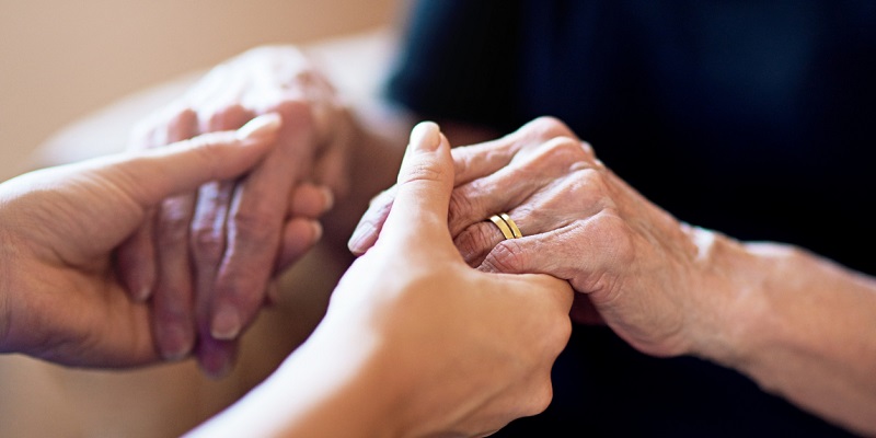 Young hands holding an old lady's hands Young hands holding an old lady's hands