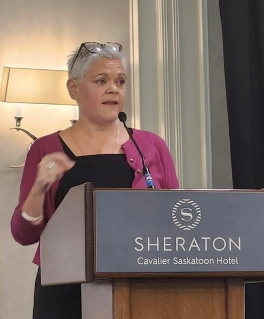 Photo showing Liz Walsh at a podium addressing International Conference on the Nurse’s Role in the Criminal Justice System in October 2025