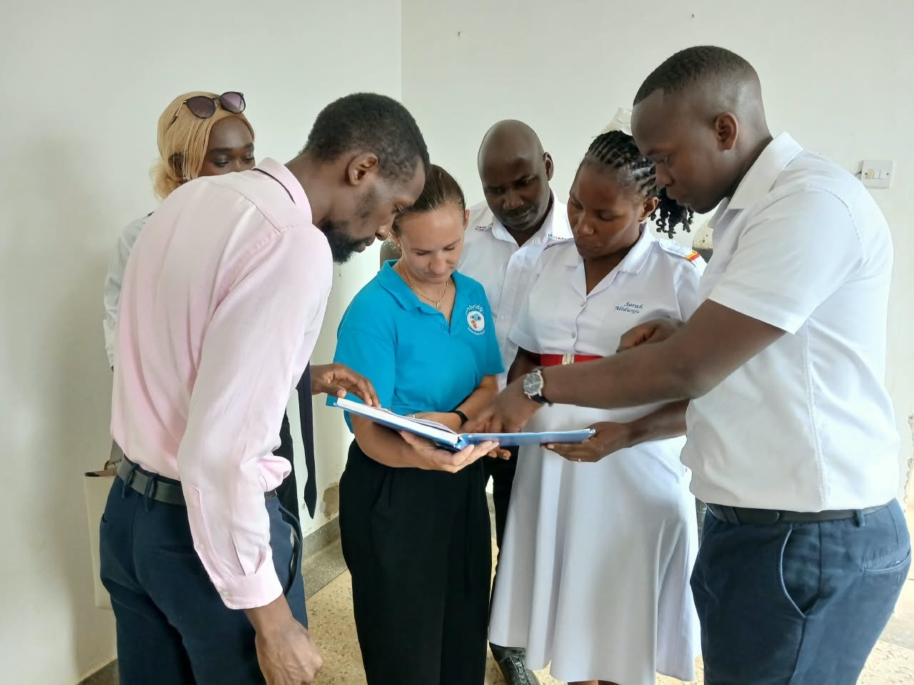Group of men and women viewing viewing a document