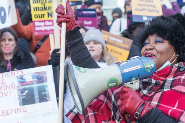A woman at a demonstration holding a megaphone