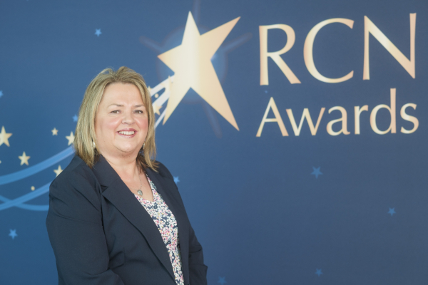 Photo of Amanda Milward standing next to an 'RCN Awards' logo