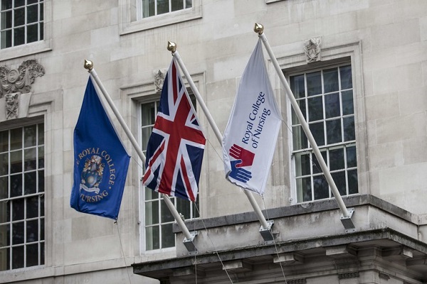 The exterior of the Royal College of Nursing office on Cavendish Square, including two Royal College of Nursing flags and a Union Jack