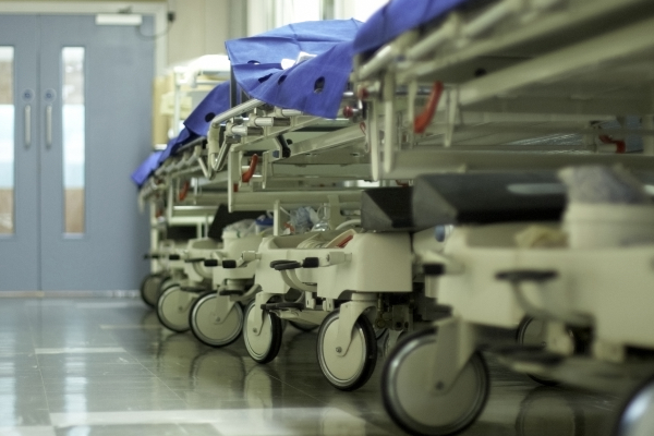 Image of patient's beds lined up in the corridor
