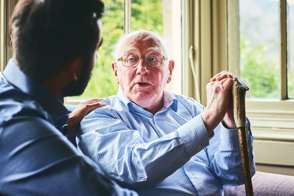 Older man talking to nurse