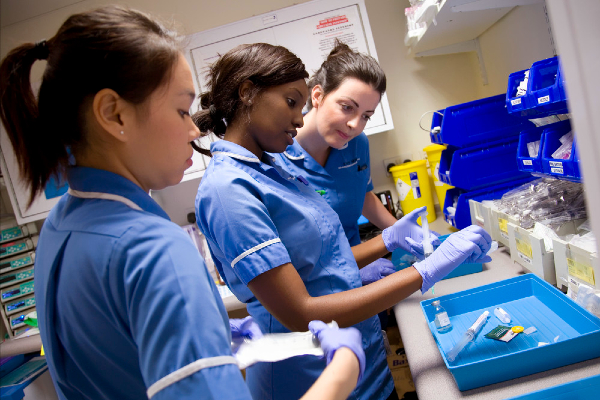 Three nurses dispensing medicines