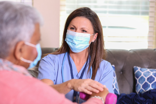 Nurse and client wearing face masks