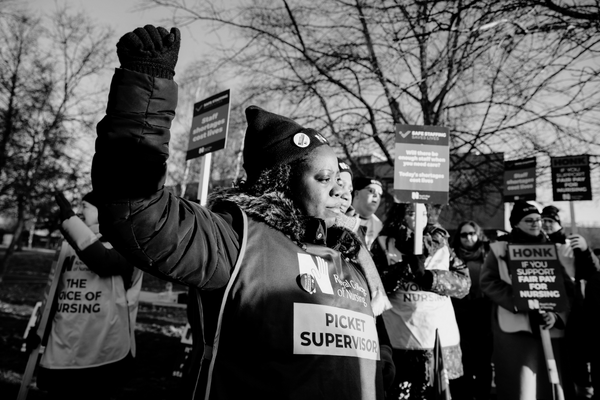 Nurse on picket line wearing a 'picket supervisor' tabard