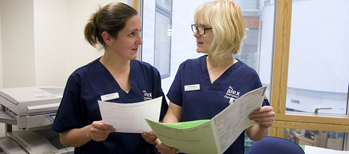 Two nurses looking at one another