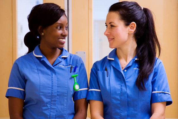 Two nurses looking at one another