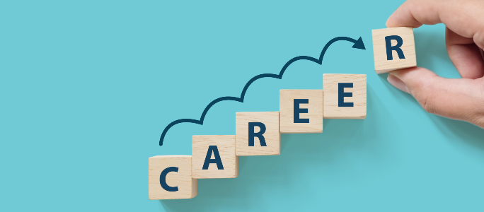 Career Coaching hand placing alphabet blocks that spell out the word "career"