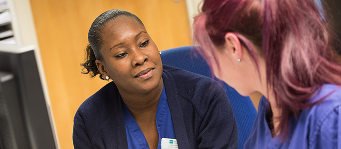 Nursing staff looking at guidance