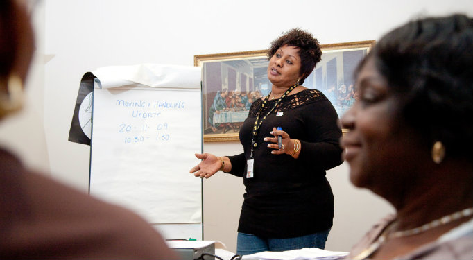 training leader standing next to flip-chart