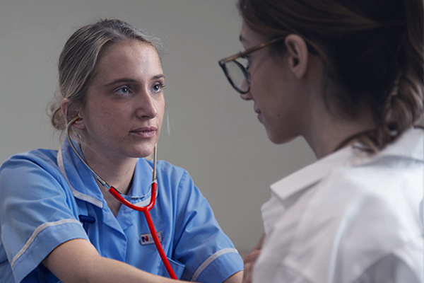 A nurse checking someone's heartbeat