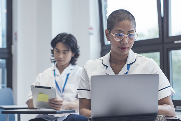A nursing student working on a laptop