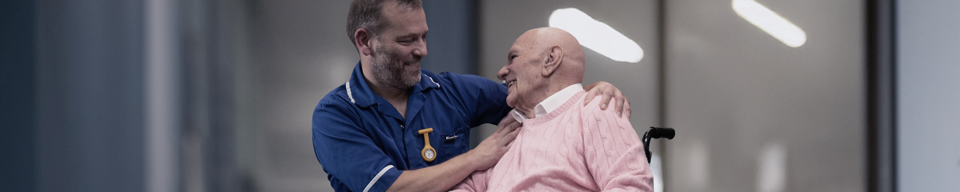 A nurse and patient talking to each other and smiling