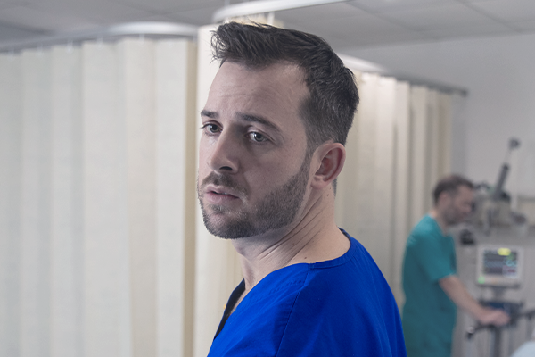 A nurse looking over his shoulder